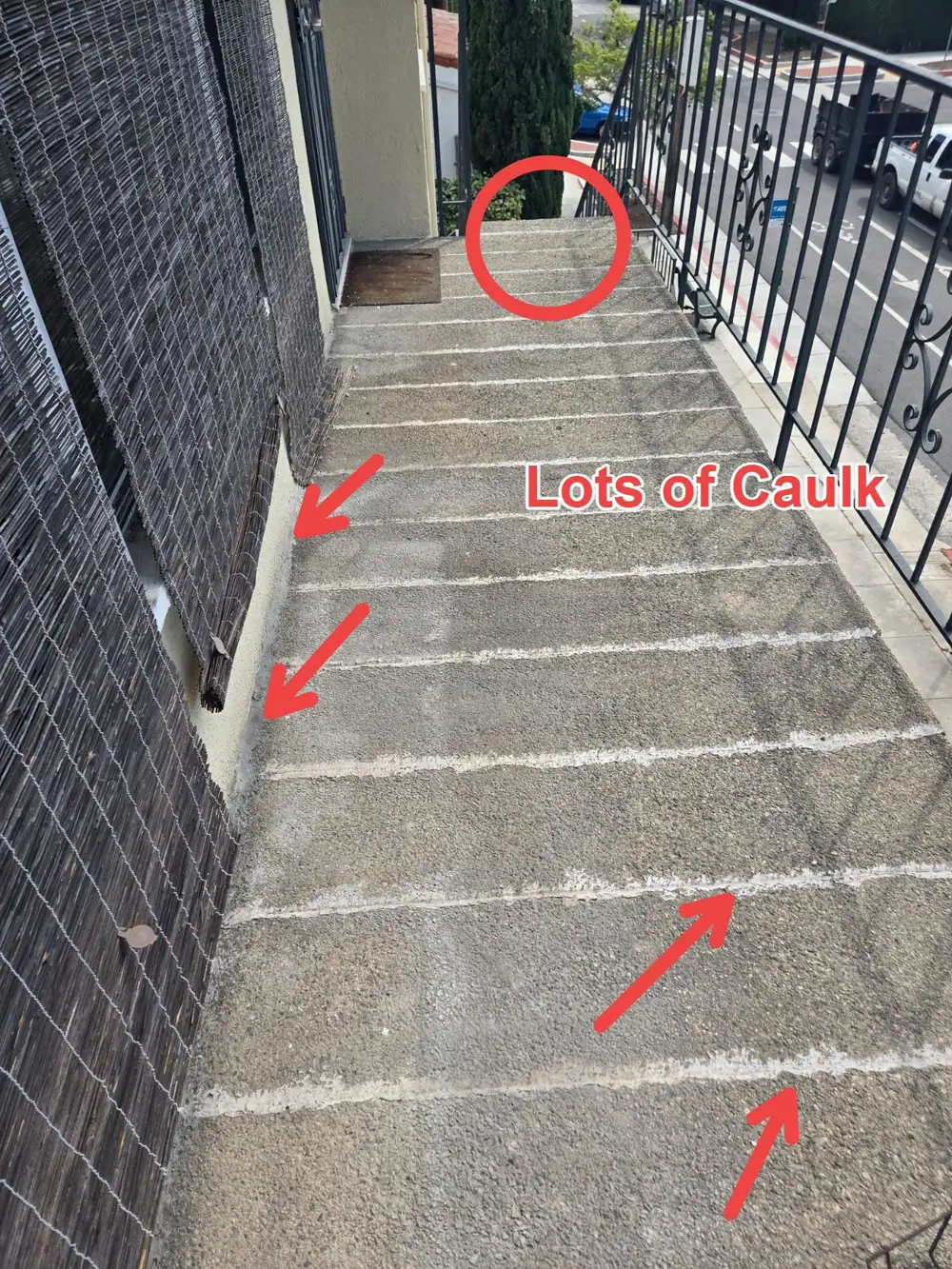Elevated walkway deck with joints heavily filled with caulk instead of a waterproof membrane