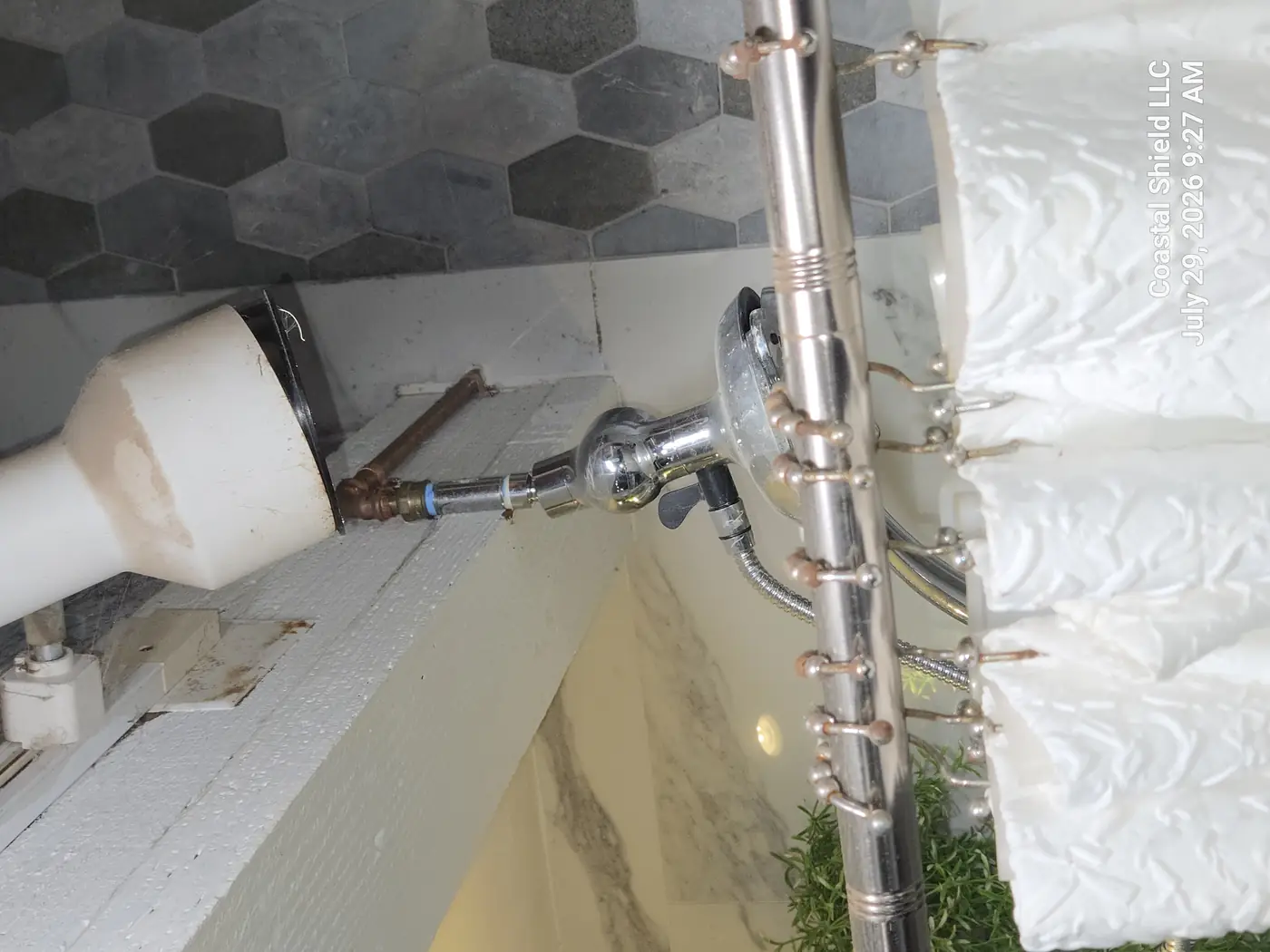 Improvised shower supply using a push-fit fitting on exposed copper with staining below