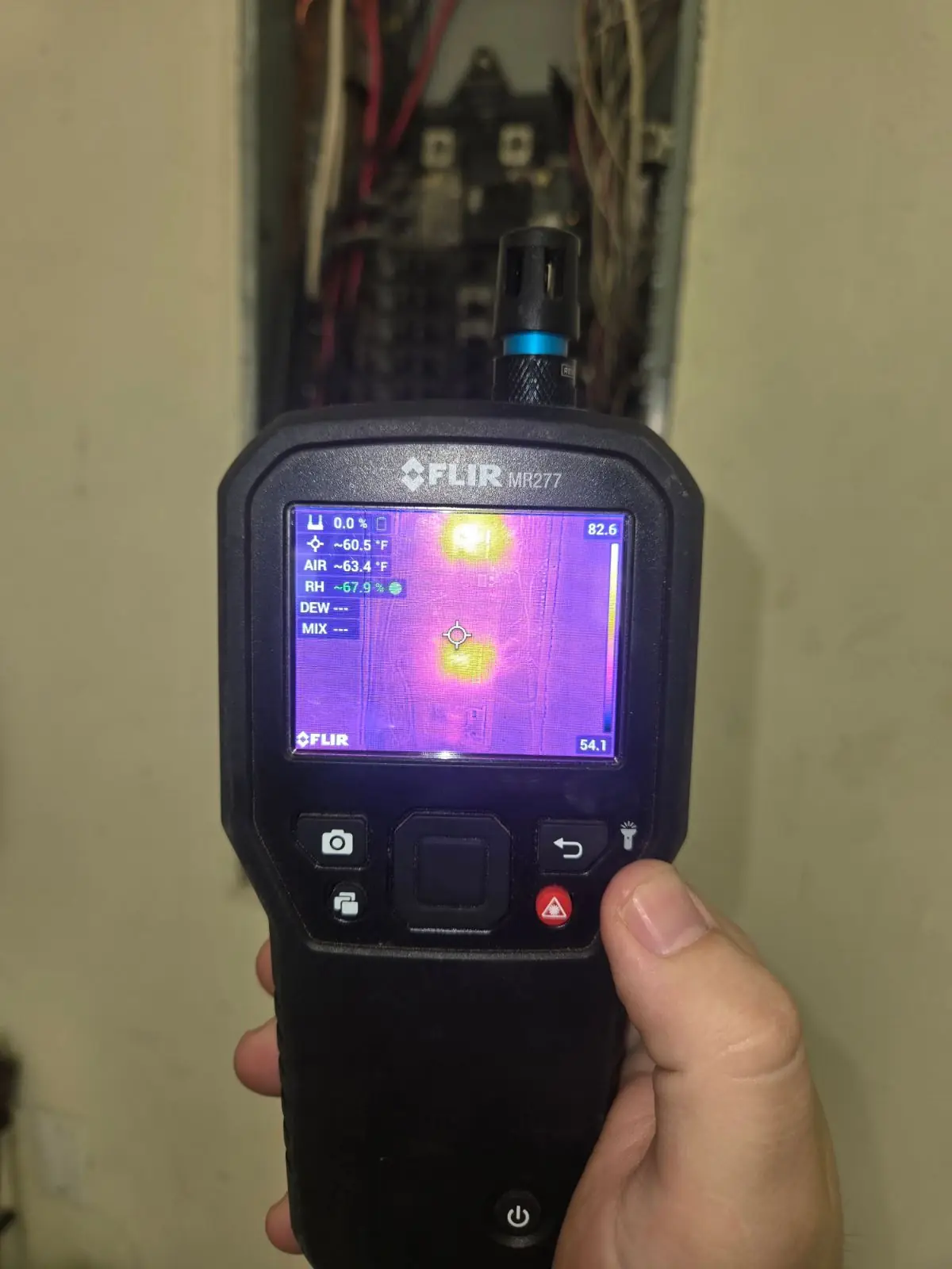 FLIR thermal camera showing a hotspot inside a main electrical panel