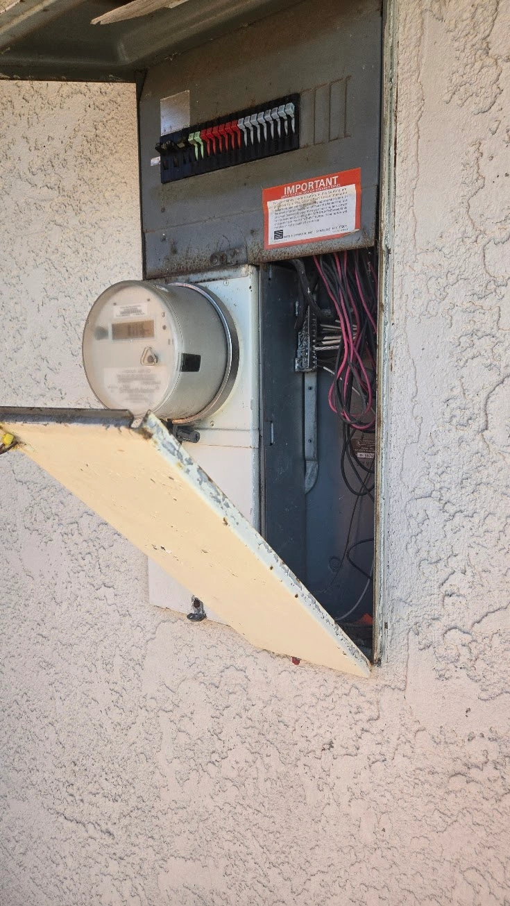 Close-up photo of a Zinsco electrical panel with visible corrosion and aging components.