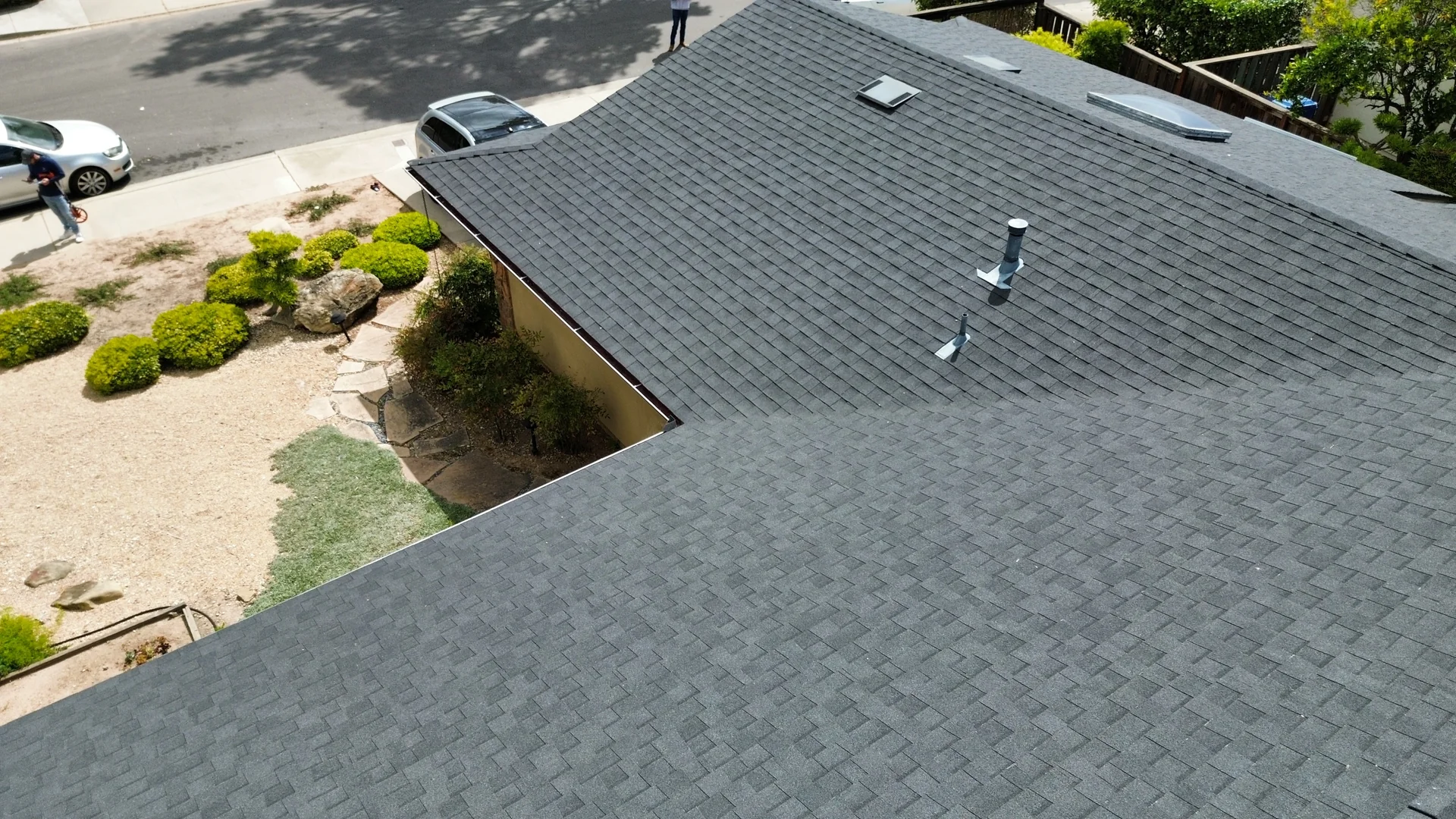 Aerial drone view of a Santa Barbara composition-shingle roof showing vents, pipe boots, and ridge in clear detail