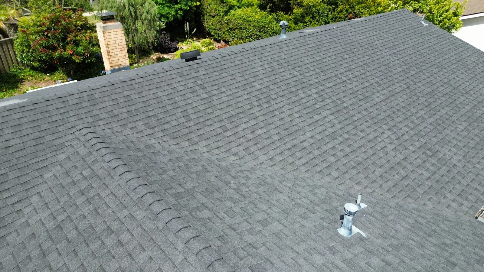 Aerial overview of a composition-shingle roof in Santa Barbara showing ridge, vents, and pipe boots in clean condition