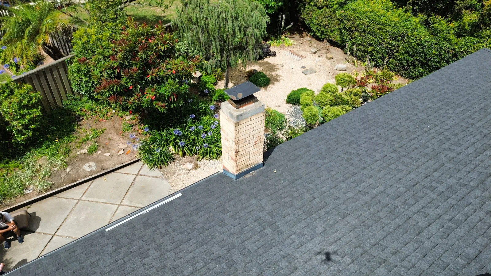 Aerial drone view of an asphalt-shingle roof valley intersection on a Santa Barbara hillside property