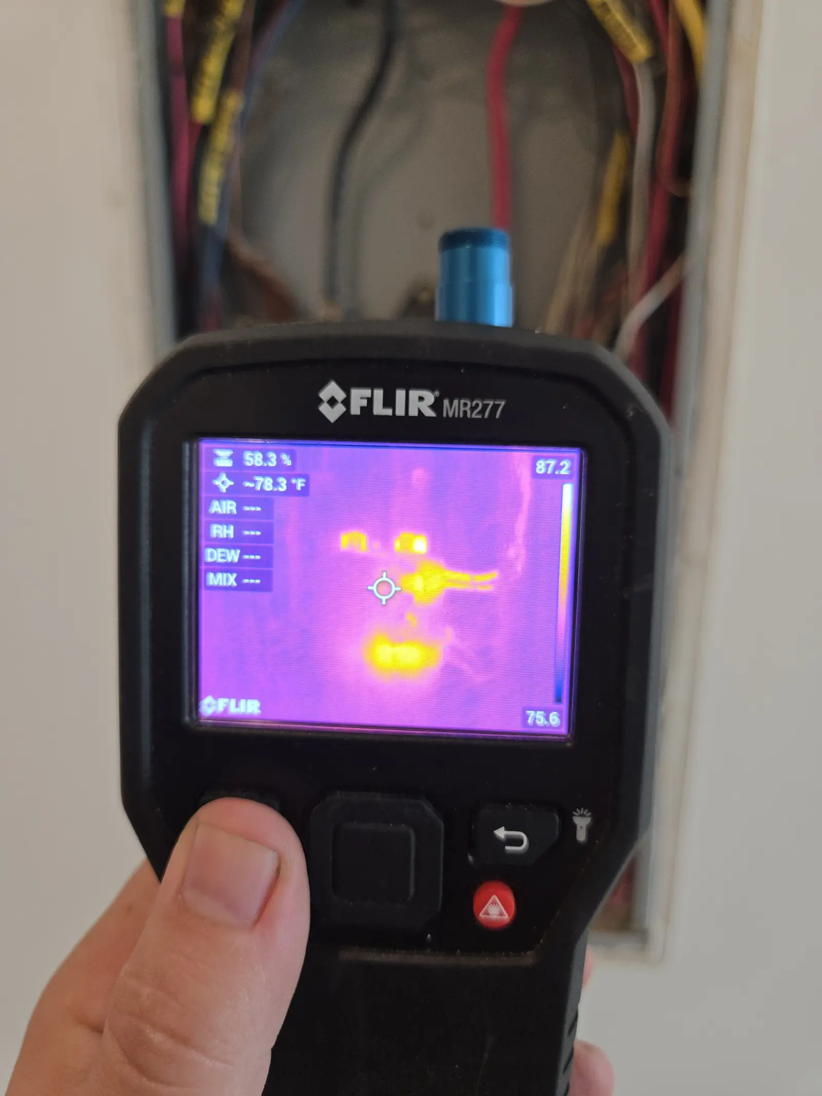 FLIR thermal imager showing heat signatures on electrical panel wiring